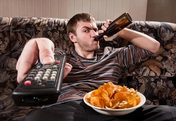 lazy guy with remote and beer